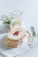 Obraz na płótnie Canvas Closeup of homemade meringue cake with strawberry on white paper