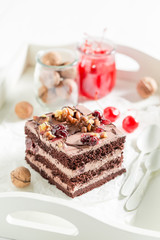 Closeup of fresh chocolate cake with cherries and nuts