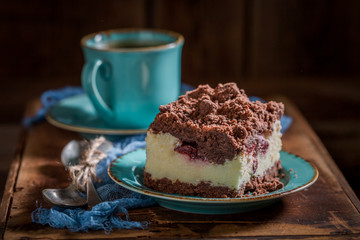 Homemade cheesecake served in blue porcelain on wooden tray