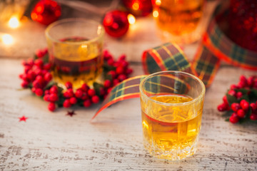Whiskey, brandy or liquor shot and Christmas decorations