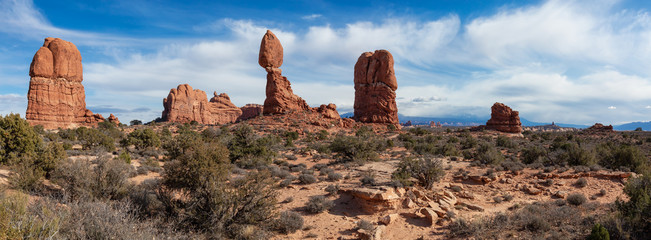 Panoramic Landscape view of beautiful red rock canyon formations during a vibrant sunny day. Taken in Arches National Park, located near Moab, Utah, United States.