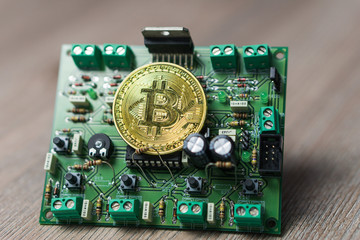 Photo of BItcoin coin on electric circuit