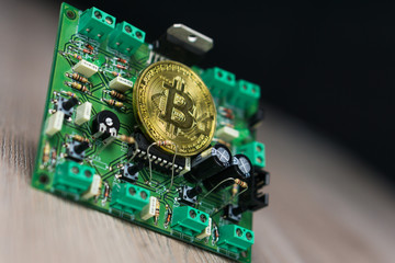 Photo of Bitcoin coin on electric circuit