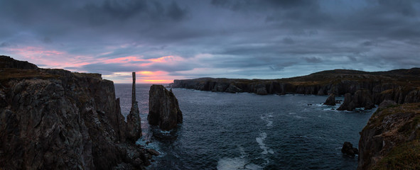 Beautiful panoramic seascape of a rocky Atlantic Ocean Coast during a cloudy sunrise. Taken in Spillars Cove, Bonavista, Newfoundland and Labrador, Canada.