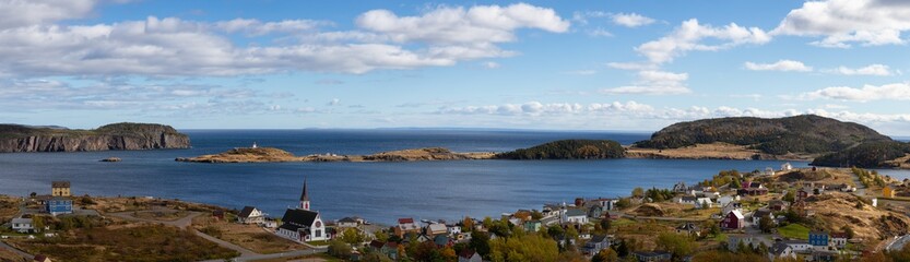 Fototapeta na wymiar Aerial panoramic view of a small town on the Atlantic Ocean Coast during a sunny day. Taken in Trinity, Newfoundland and Labrador, Canada.