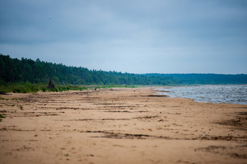 storm clouds forming over clear sea beach with rocks and clear sand