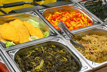 steel trays containing spinach peppers breaded cutlets