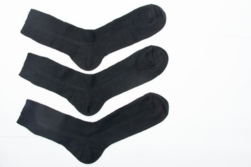 New black socks on a white background. Close-up. New purchase.