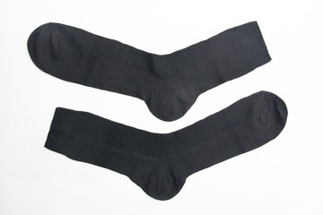 New black socks on a white background. Close-up. New purchase.