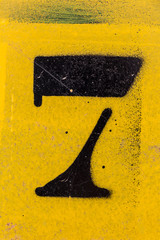 black number stencil painted on background, number 7, nunber seven