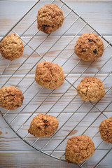 Appetizing and tasty oatmeal cookies with raisins and milk on a bright table.