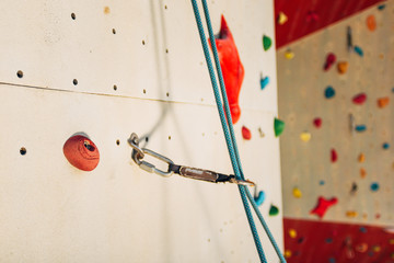 White climbing wall with colorful rocks
