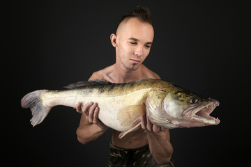young man posing with big fish