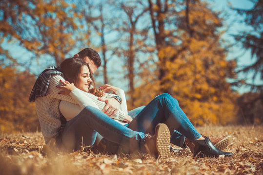 Young couple lying in the park and looking in love