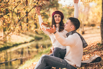 Stylish couple hugging near the river