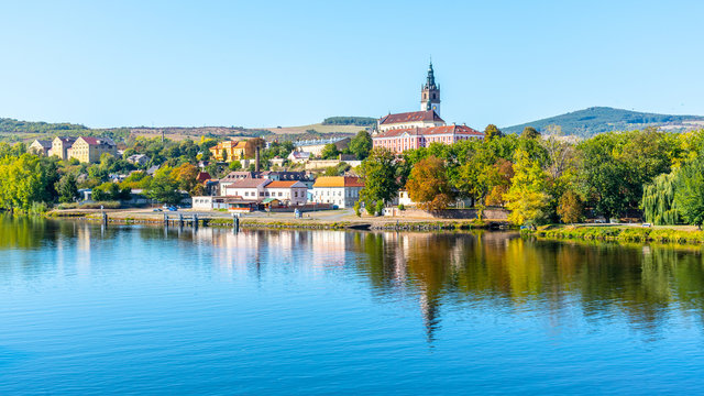 Panoramic cityscape of Litomerice reflected in Labe River, Czech Republic.