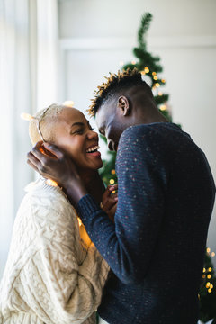 Young multiethnic lovers celebrating Christmas at home.