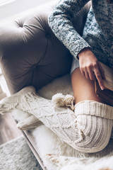 Fototapeta premium Girl reading and relaxing on a couch