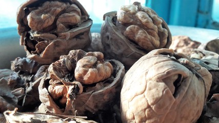 Walnuts whole and cracked in old baskets. Close-up, healthy food with rustic background
