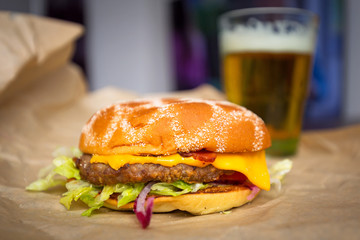 Tasty hamburger with grilled beef and glass of beer
