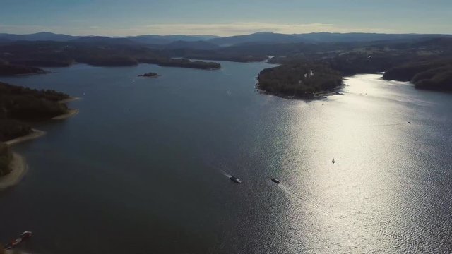 Aerial landscape with Solina Lake in Bieszczady mountains in golden morning light. 3840x2160, 30fps.