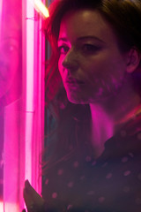 Cinematic night portrait of girl and neon lights