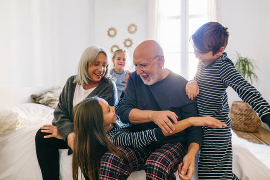 Grandpa doing magic trick to their grandchild at home.