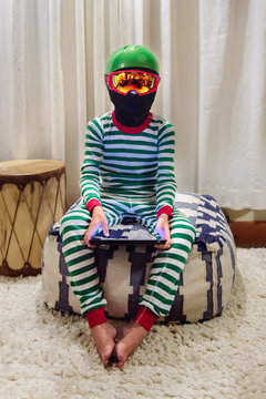 Child  in ski helmet and goggles and pyjamas