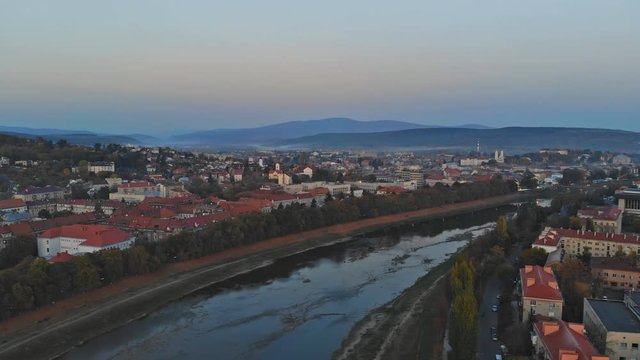 Panoramic view on a small city at sunrise above in the autumn over the Uzh River Uzhhorod Ukraine Europe