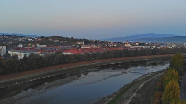 Aerial view of middle class houses in small village or town in the countryside. over the Uzh River Top view above houses at sunrise above in the autumn Uzhhorod Ukraine Europe