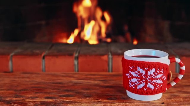 Christmas drinks on wooden table near fireplace
