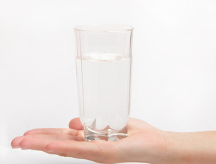 Woman hand with glass of water isolated on white background