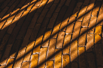 Sun rays and shadow in the brick road
