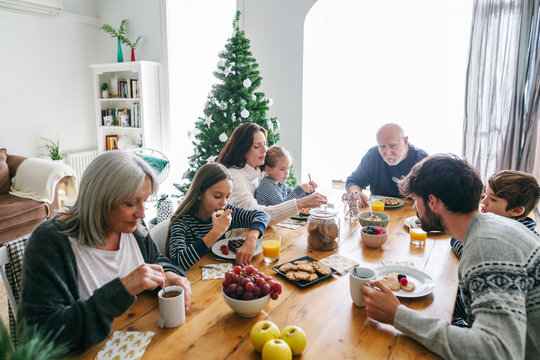 Family eating breakfast on Christmas morning. 