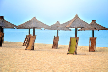 umbrellas on the beach. empty beach with straw umbrels