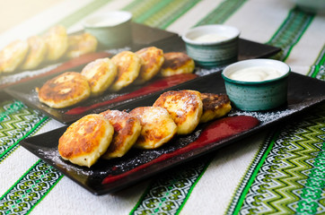 curd pancakes. Cheesecake with sour cream and strawberry sauce. cheese pancakes 