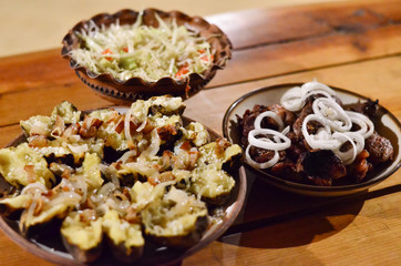 dishes of Transcarpathian cuisine. Potatoes with cracklings and cheese. grilled meat. Zakarpattia,
