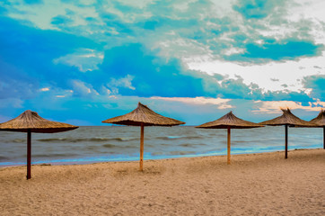 empty beach with straw umbrellas