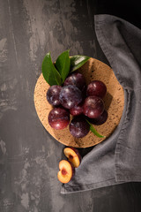Red plums in a cork plate