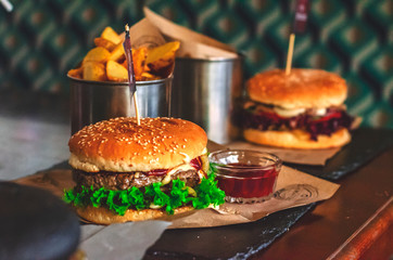 juicy meat burger with cheese, herbs and light bread with sesame seeds