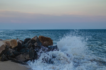 Obraz premium the waves beat on the stones. storm on the azure seashore. sea and rocks