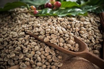 Cup of coffee, bag and scoop on old rusty background