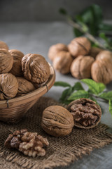 Walnuts in wooden bowl. Whole walnut on table