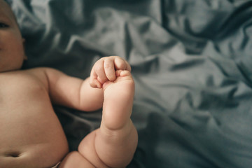 3 month old baby learning to grab his feet