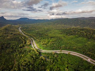 Top View of Rural Road, Path through the green forest and countryside of Thailand, Top view aerial photo from drone