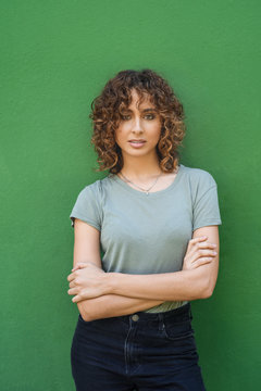 Wonderful young model posing against green