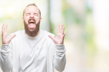 Young caucasian hipster man wearing sport clothes over isolated background crazy and mad shouting and yelling with aggressive expression and arms raised. Frustration concept.