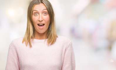 Fototapeta premium Young beautiful woman wearing winter sweater over isolated background afraid and shocked with surprise expression, fear and excited face.
