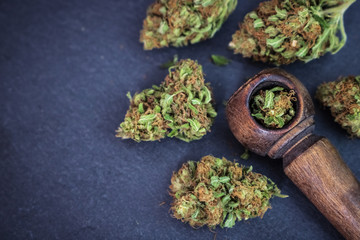 Marijuana flower with wooden pipe 