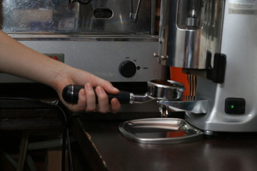 barista pressing coffee. barista hold coffee cone